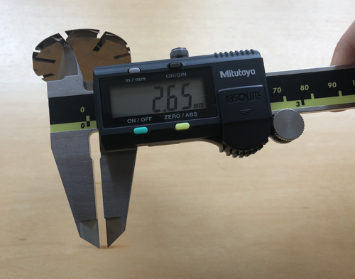 Measuring cardboard piece with calipers