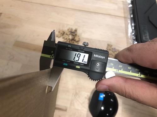 Using callipers to measure cardboard thickness